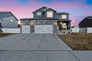 View of front of property featuring concrete driveway, an attached garage, fence, a porch, and stucco siding