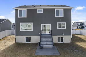 Back of property featuring a residential view, a fenced backyard, and stucco siding