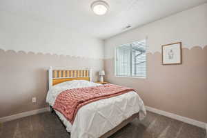 Bedroom featuring baseboards, visible vents, and carpet