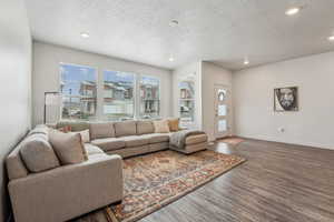 Living room with recessed lighting, baseboards, and wood finished floors
