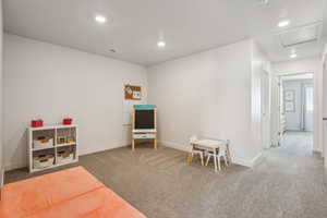 Rec room with carpet flooring, recessed lighting, baseboards, and visible vents