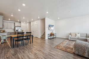 Dining area with baseboards, stairs, wood finished floors, and recessed lighting