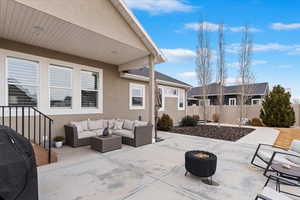 View of patio / terrace featuring a grill, an outdoor living space with a fire pit, and fence