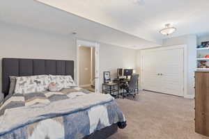 Bedroom featuring a closet, carpet, visible vents, and baseboards