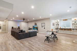 Living room featuring recessed lighting, visible vents, light wood-style flooring, and baseboards