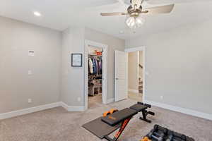 Exercise room featuring light carpet, recessed lighting, a ceiling fan, and baseboards