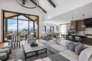 Living area with high vaulted ceiling, beamed ceiling, wood finished floors, and recessed lighting