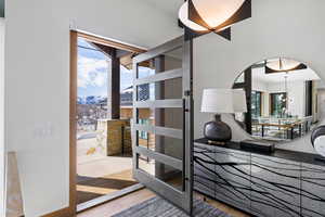 Interior space with arched walkways, a mountain view, and light wood finished floors