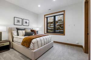 Bedroom with recessed lighting, light colored carpet, visible vents, and baseboards