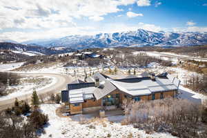 Snowy aerial view featuring a mountain view