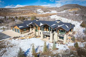 Snowy aerial view featuring a mountain view