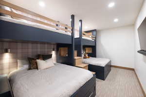 Bedroom with baseboards, an accent wall, recessed lighting, and light colored carpet