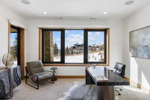 Office space featuring light carpet, recessed lighting, visible vents, and baseboards