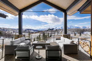 Interior space featuring a mountain view and an outdoor living space with a fire pit