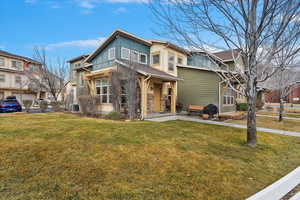 View of front of property featuring a residential view, fence, a front lawn, and central air condition unit