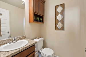 Bathroom featuring vanity and toilet