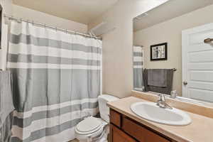 Bathroom featuring toilet, visible vents, and vanity