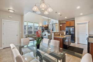 Dining room with a notable chandelier, recessed lighting, visible vents, light tile patterned flooring, and a textured ceiling