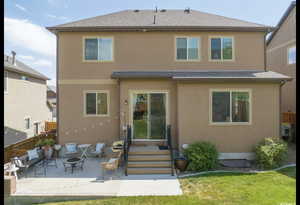 Rear view of house featuring a patio, an outdoor fire pit, a shingled roof, fence, and stucco siding
