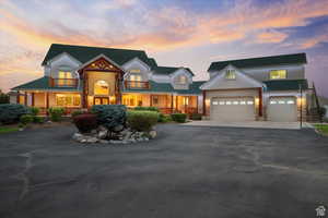 View of front of house featuring a garage, covered porch, driveway, and stucco siding