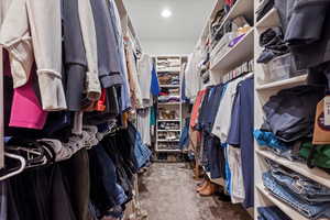 Walk in closet with carpet flooring