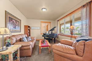 Carpeted living room featuring baseboards