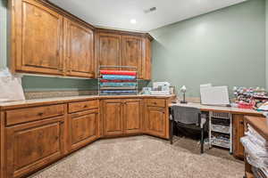 Office with visible vents and light colored carpet