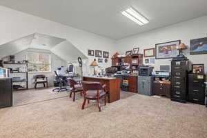 Office with lofted ceiling and carpet floors