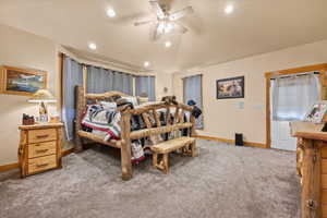 Carpeted bedroom featuring baseboards, vaulted ceiling, and recessed lighting