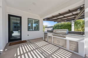 View of patio / terrace featuring grilling area, a pergola, and exterior kitchen