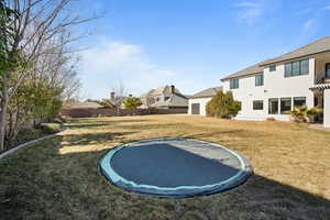 View of yard featuring a trampoline