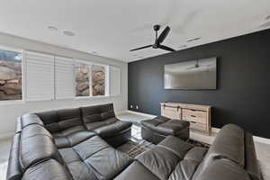 Home theater with carpet flooring and ceiling fan