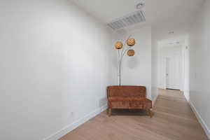 Living area with light hardwood / wood-style flooring