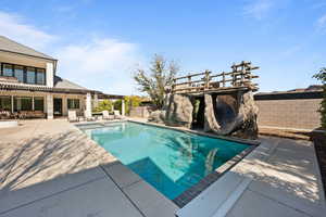 View of pool featuring a patio area and a pergola