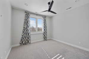 Unfurnished room featuring light carpet and ceiling fan