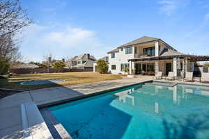 View of swimming pool with a pergola, a lawn, and a patio