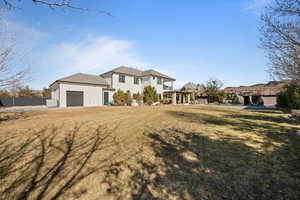 View of front of property featuring a garage and a front yard