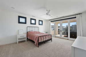 Bedroom featuring light carpet, access to outside, french doors, and ceiling fan