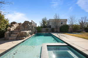 View of swimming pool with an in ground hot tub