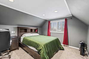 Bedroom featuring lofted ceiling and light colored carpet