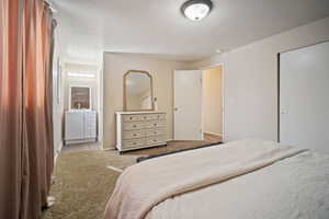 Bedroom featuring light colored carpet and baseboards