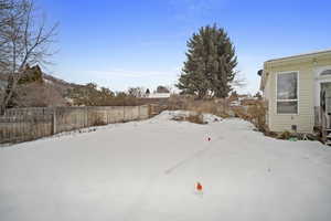 Snowy yard with fence