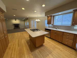 Kitchen with light countertops, appliances with stainless steel finishes, a sink, and a center island