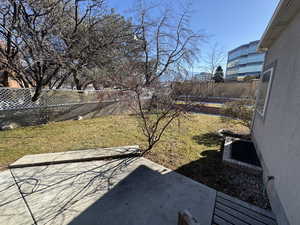 View of yard featuring a trampoline and a patio area