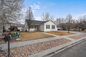 Ranch-style house with covered porch, concrete driveway, and central air condition unit