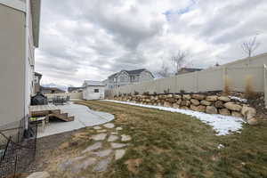 View of yard featuring a residential view, a patio area, an outdoor structure, and a fenced backyard