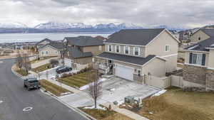 Extra wide garage. Drone / aerial view featuring a residential view and a water and mountain view