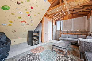 Living room featuring beverage cooler and vaulted ceiling