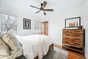 Bedroom featuring ceiling fan, a closet, light wood-type flooring, and baseboards