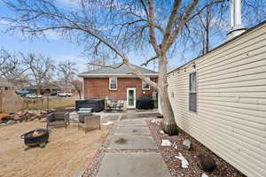 Exterior space featuring a hot tub, fence, a fire pit, and grilling area